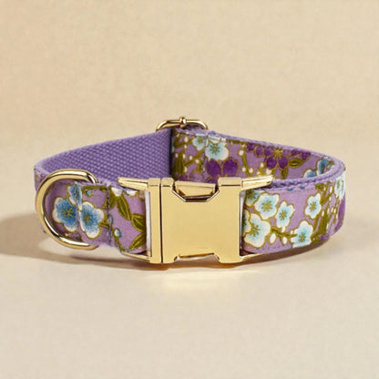 Floral-patterned dog collar with a gold buckle on a beige background