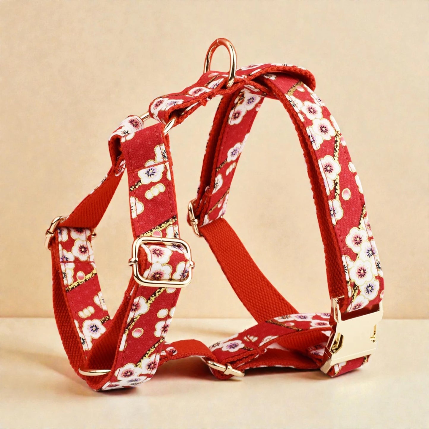 Red floral-patterned dog harness on a beige background