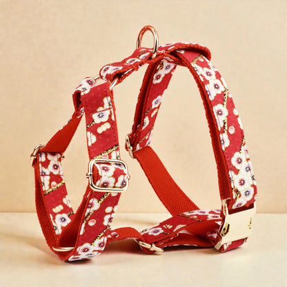 Red floral-patterned dog harness on a beige background