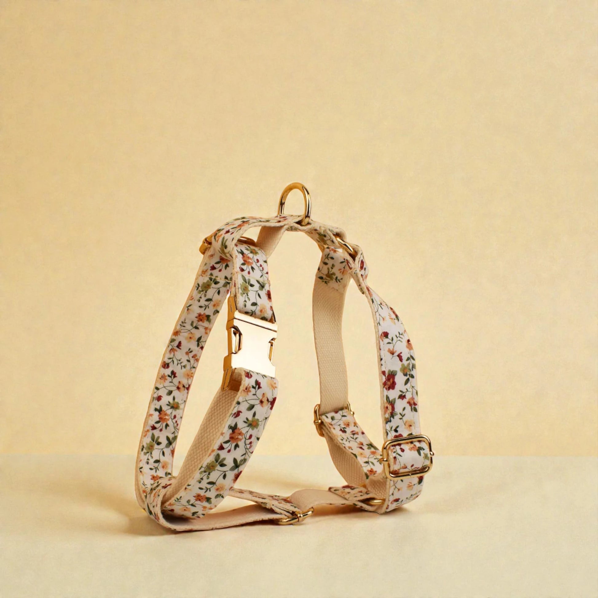 Floral-patterned dog harness on a beige background