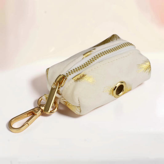 Golden feather dog poop bag holder with a gold zip and clip