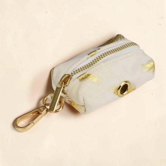 Golden feather dog poop bag holder with a gold zip and clip