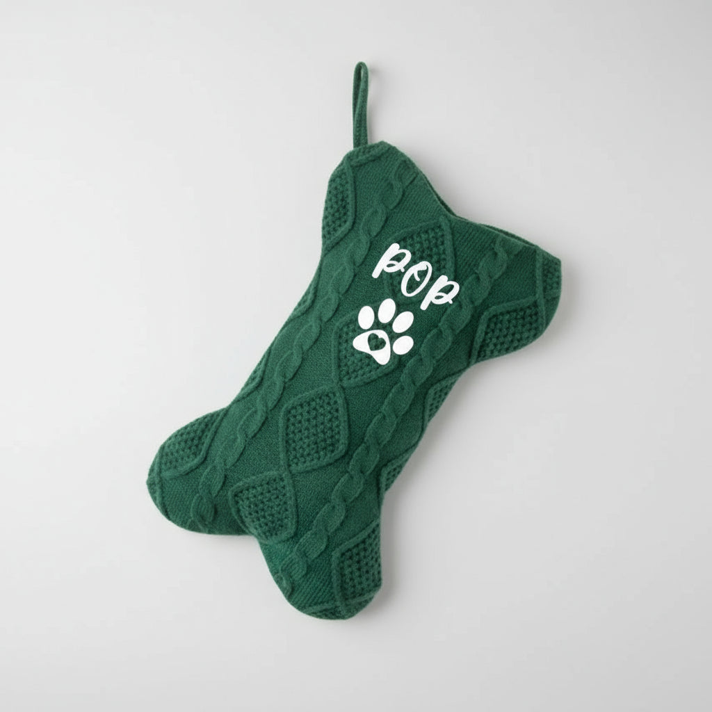Green knitted dog-shaped stocking with 'POP' and paw print on a white background