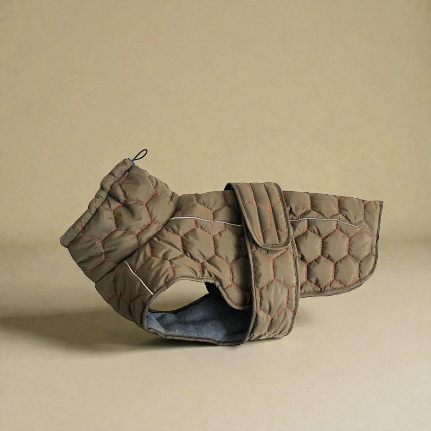 Quilted dog coat on a beige background