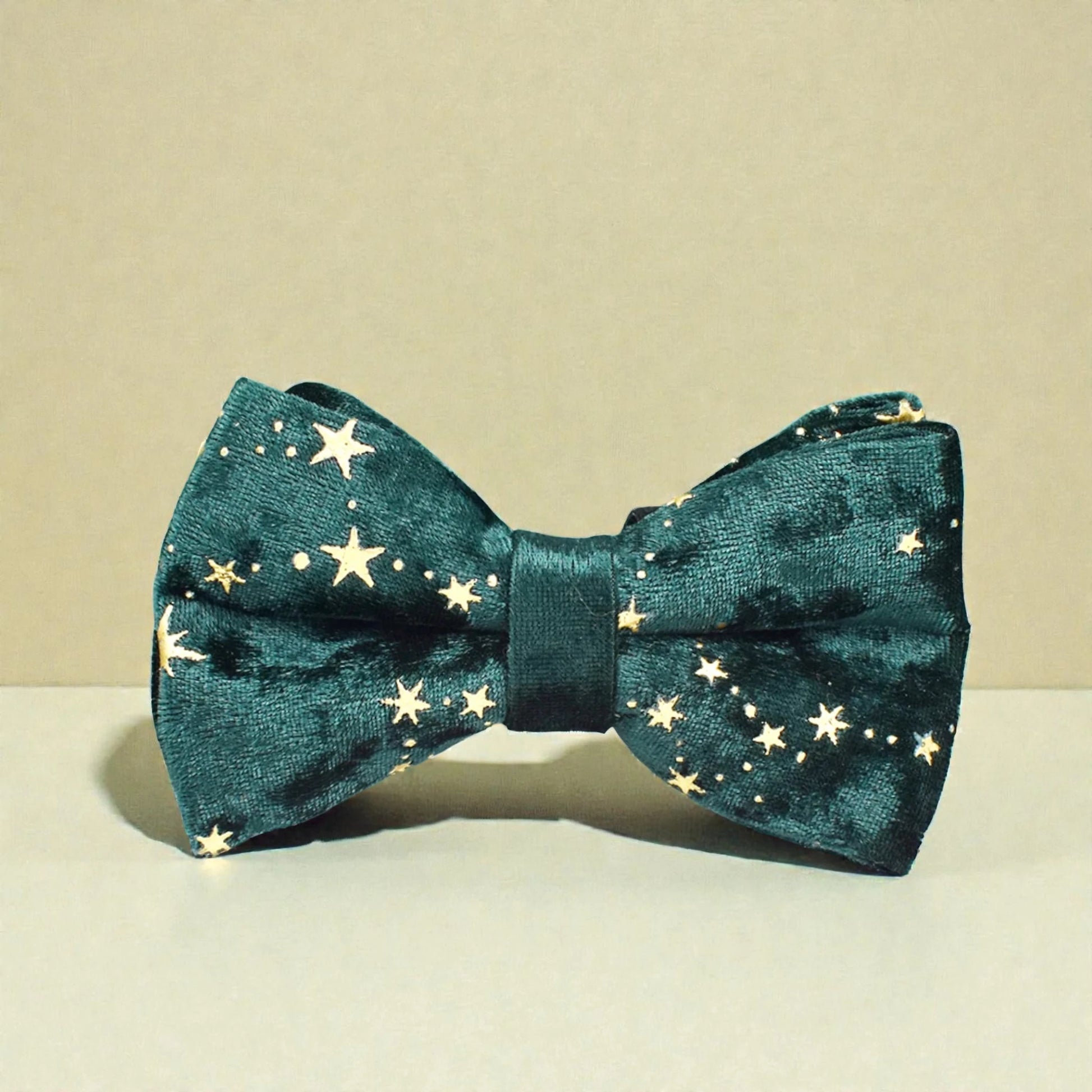 Green bow tie with star pattern on a beige background