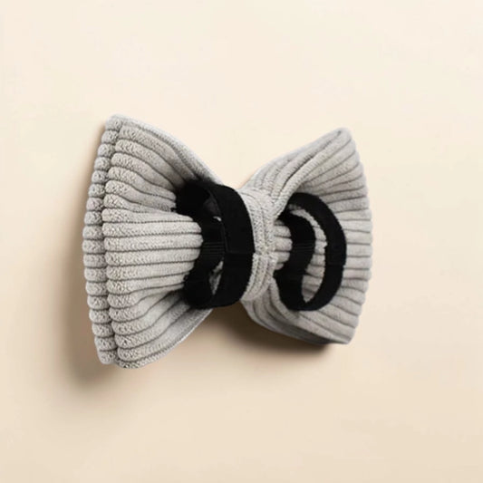 Grey corduroy dog bow on a beige background
