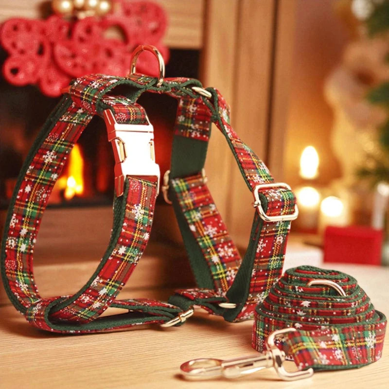 Red and green plaid dog harness and lead set on a wooden surface with a warm background.