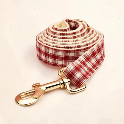 Heritage check dog lead with a red and cream plaid pattern and a shiny gold metal clasp.