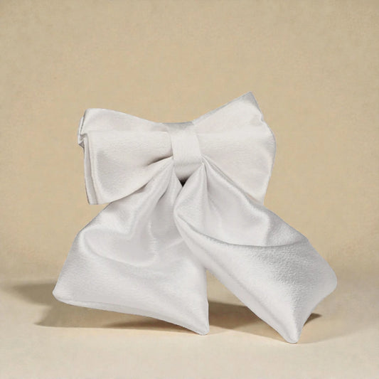 Ivory decorative dog bow on a beige background