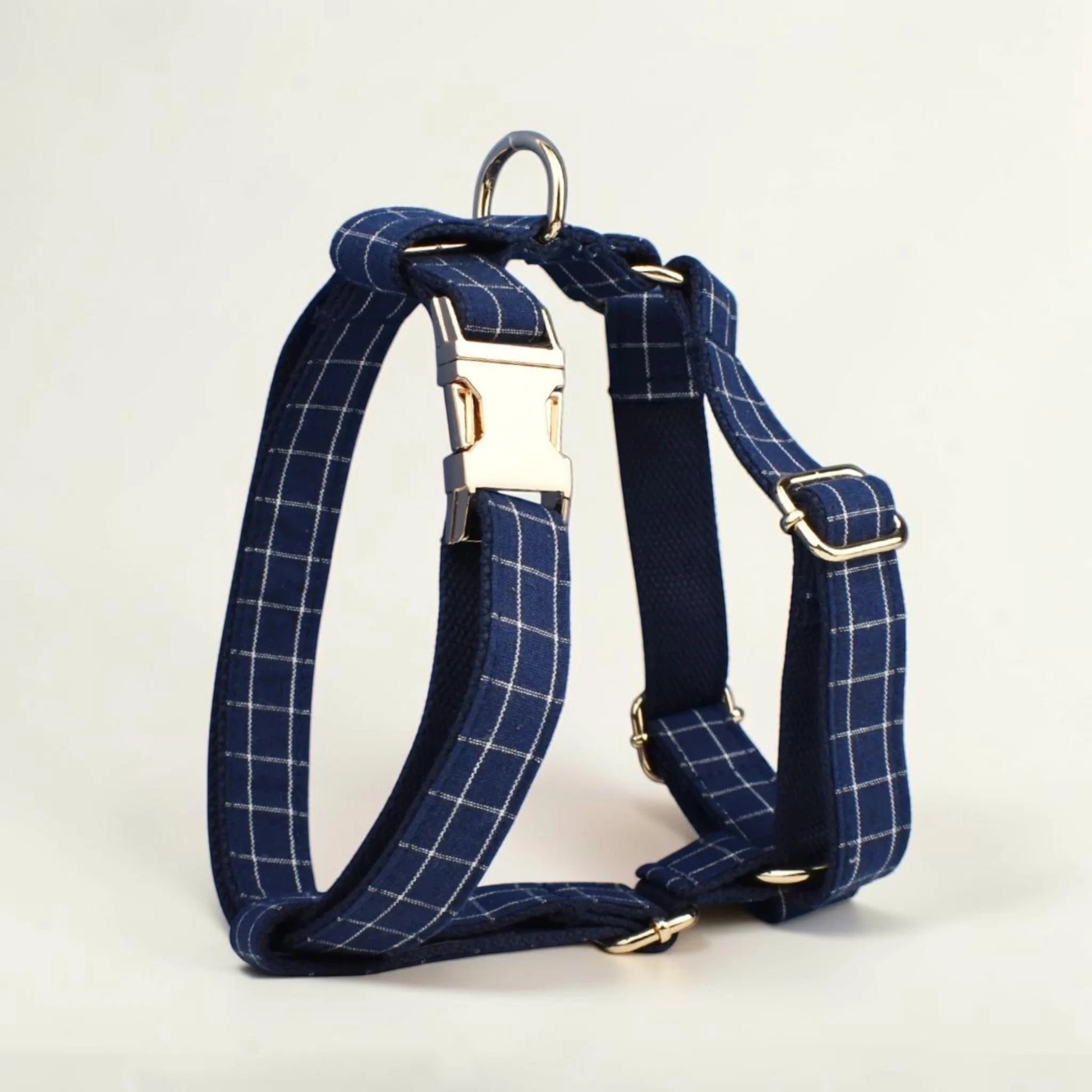 Navy check dog harness on a light beige background