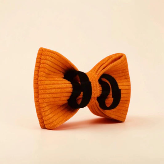 Orange detachable corduroy bow tie on a beige background