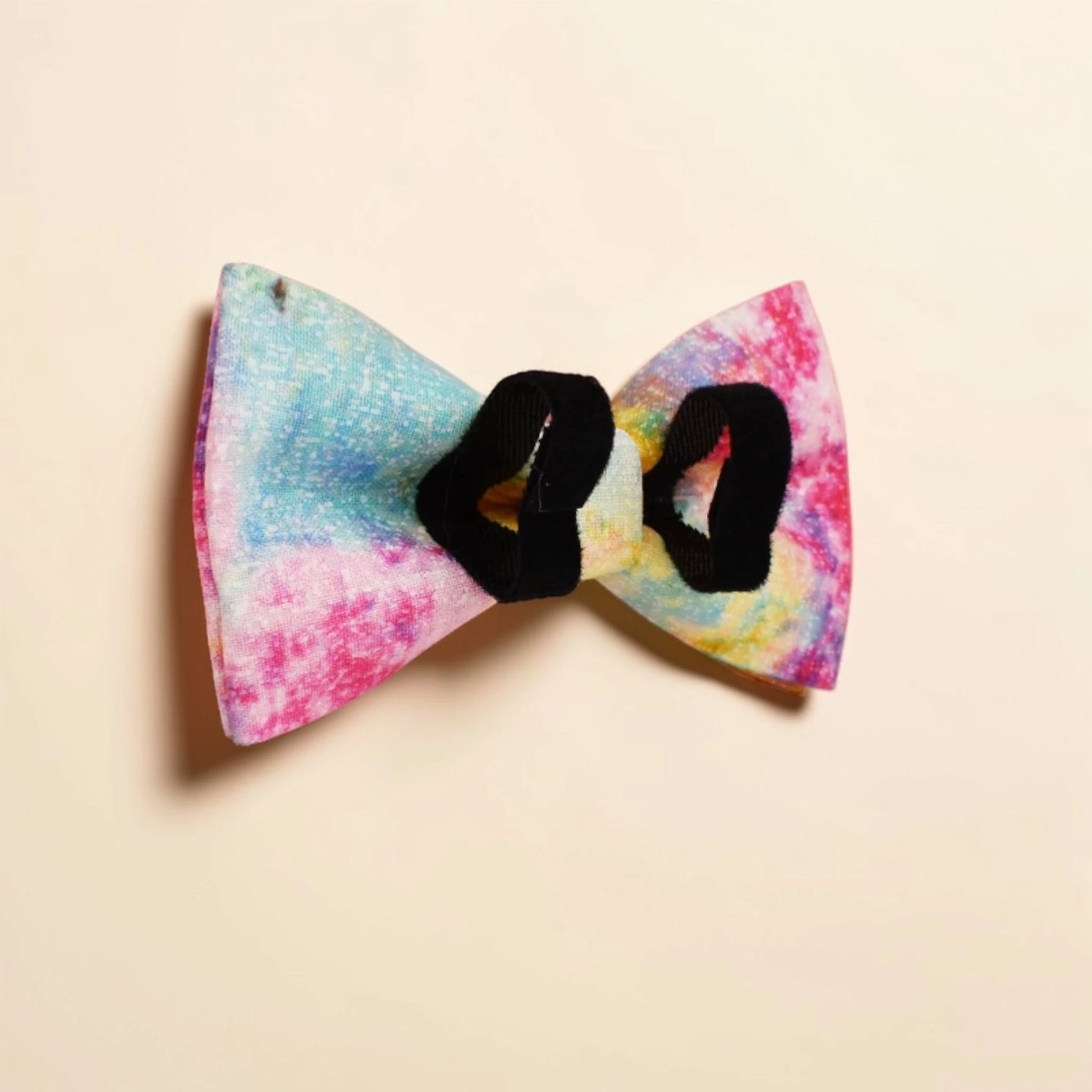 Colourful bow-shaped detachable dog bow tie on a beige background