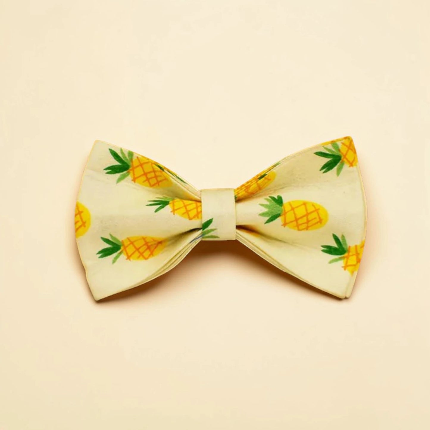 Bow tie with pineapple pattern on a beige background