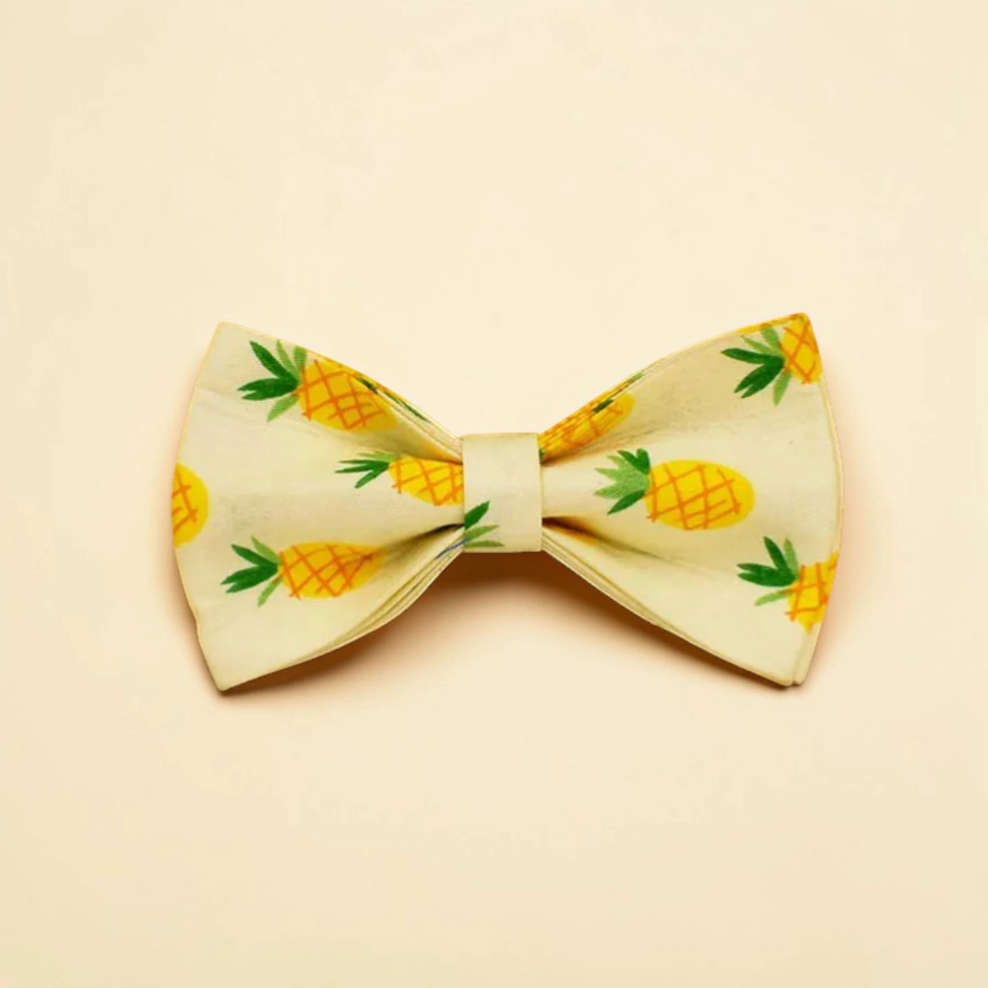 Bow tie with pineapple pattern on a beige background