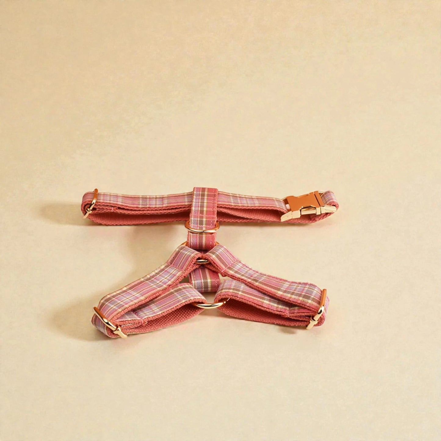 Pink plaid dog harness on a beige background