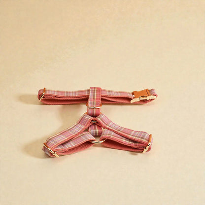 Pink plaid dog harness on a beige background