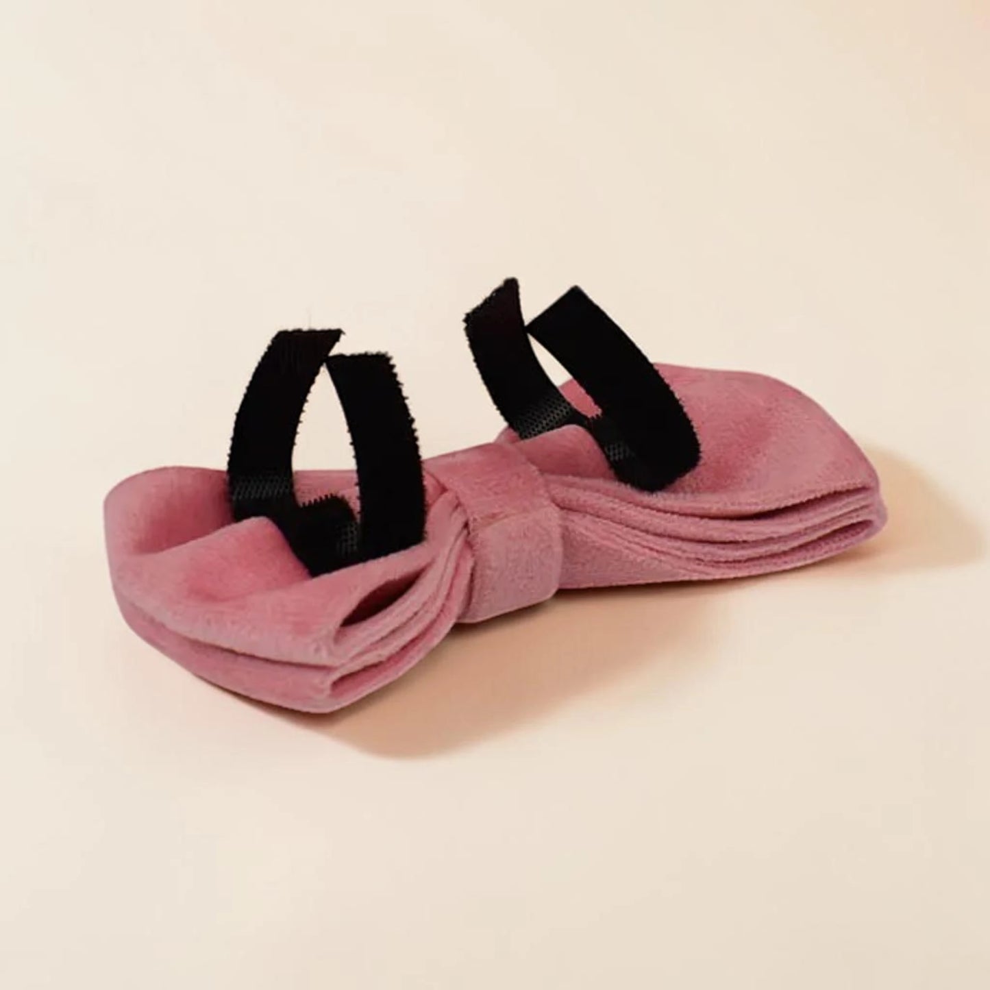 Pink dog bow tie on a beige background