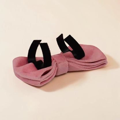 Pink dog bow tie on a beige background
