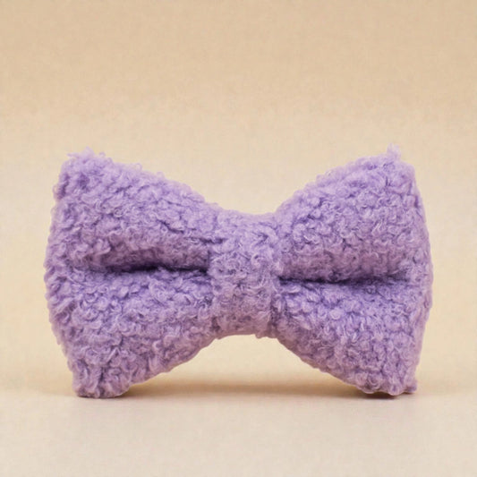 Purple teddy fleece dog bow tie on a beige background