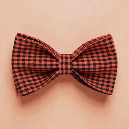 Red and black checkered bow tie on a beige background