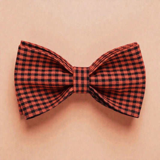 Red and black checkered bow tie on a beige background