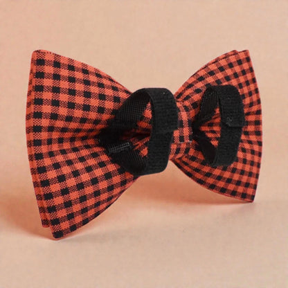 Red and black checkered bow tie on a beige background