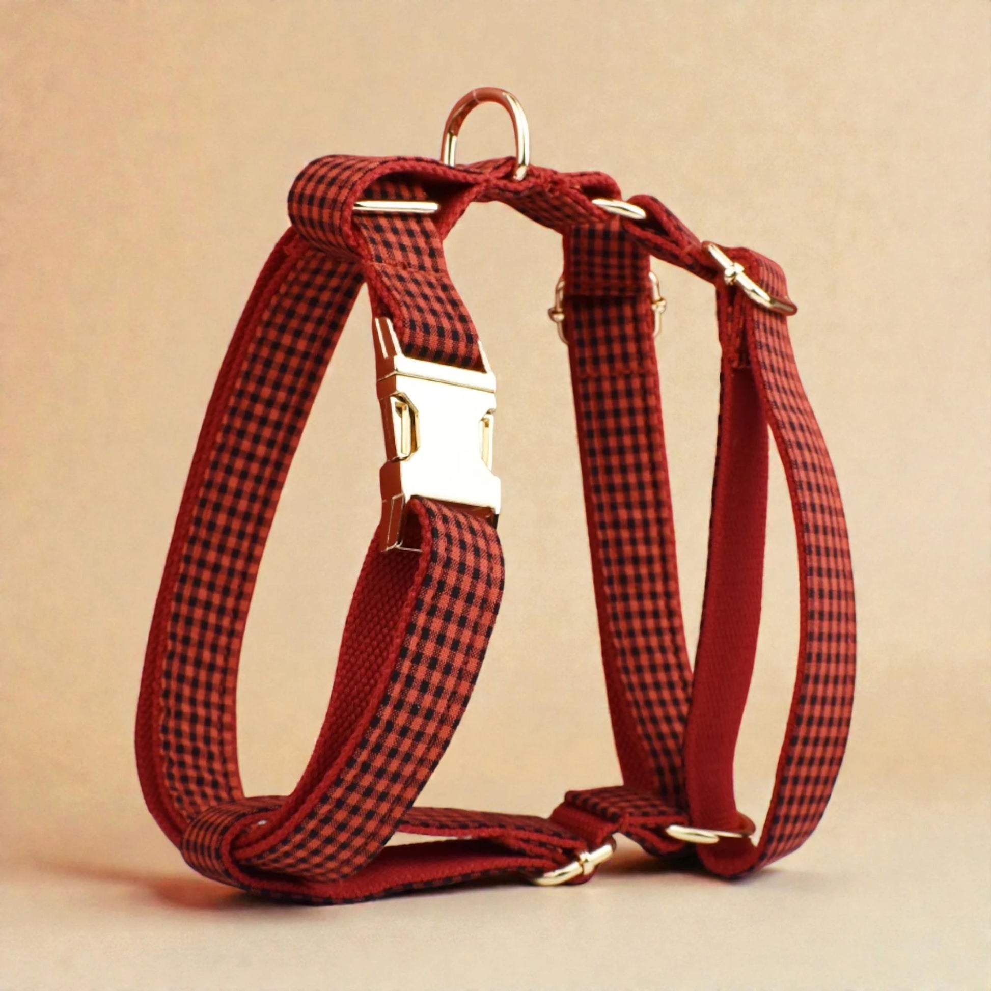 Red and black checkered dog harness on a beige background