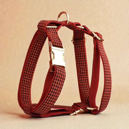 Red and black checkered dog harness on a beige background
