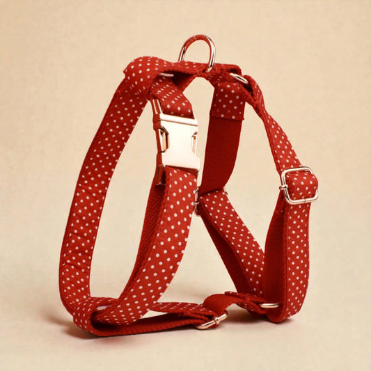 Red polka dot dog harness on a beige background
