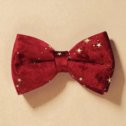 Red bow tie with gold star patterns on a beige background