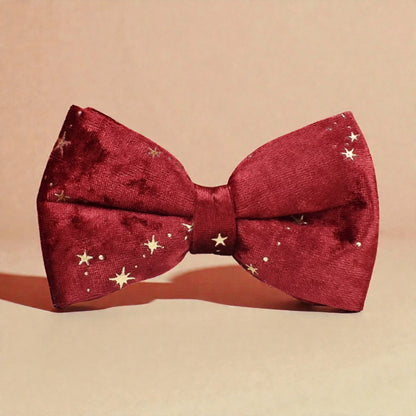Red bow tie with gold star patterns on a beige background