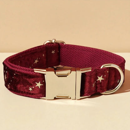 Red dog collar with star pattern and gold buckle on a beige background