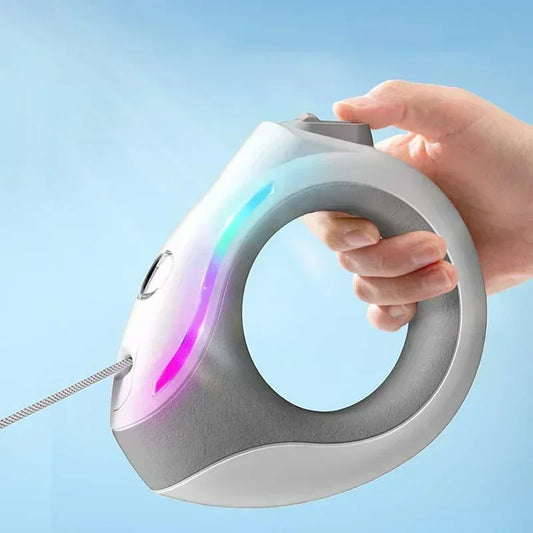 Hand holding a retractable dog lead with glowing elements against a light blue background