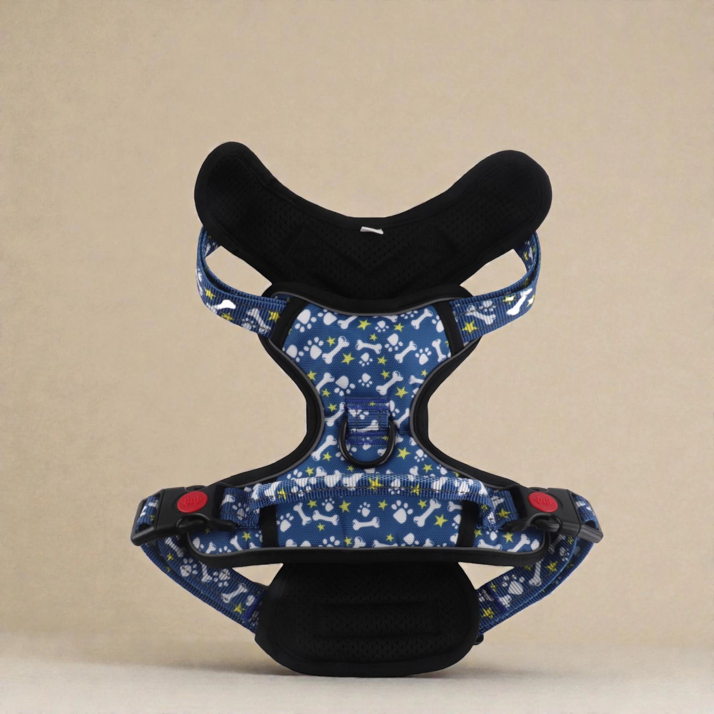 Blue dog harness with paw and bone pattern on a beige background