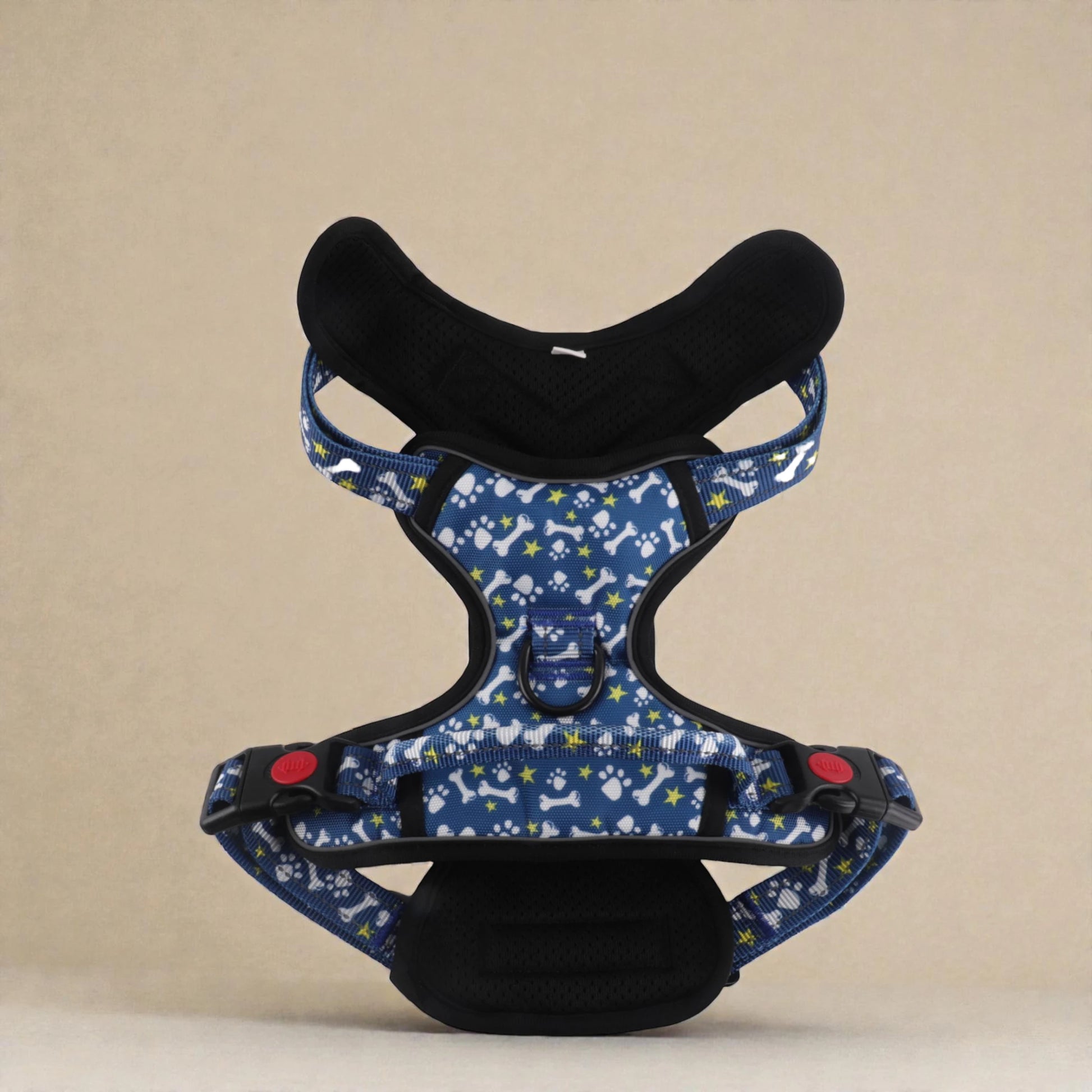 Blue dog harness with paw and bone pattern on a beige background