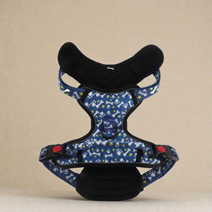 Blue dog harness with paw and bone pattern on a beige background