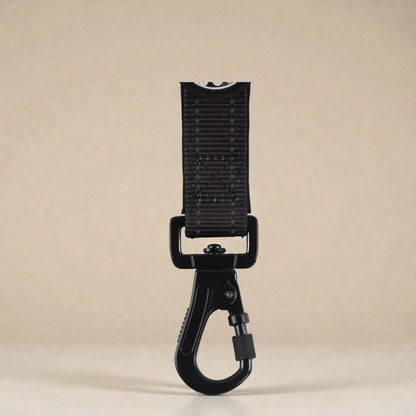 Black carabiner clip on a beige background