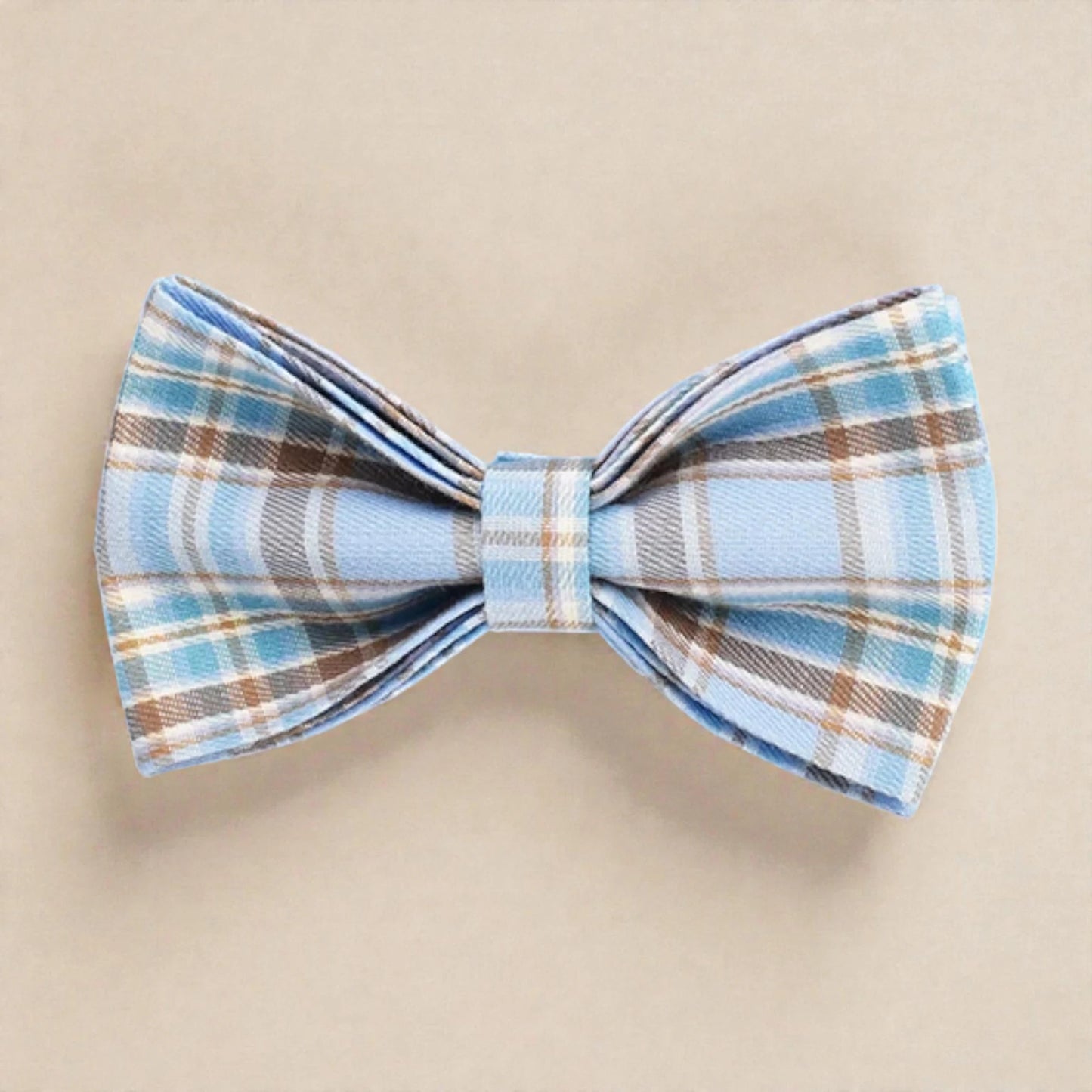 Plaid bow tie with blue and brown pattern on a beige background