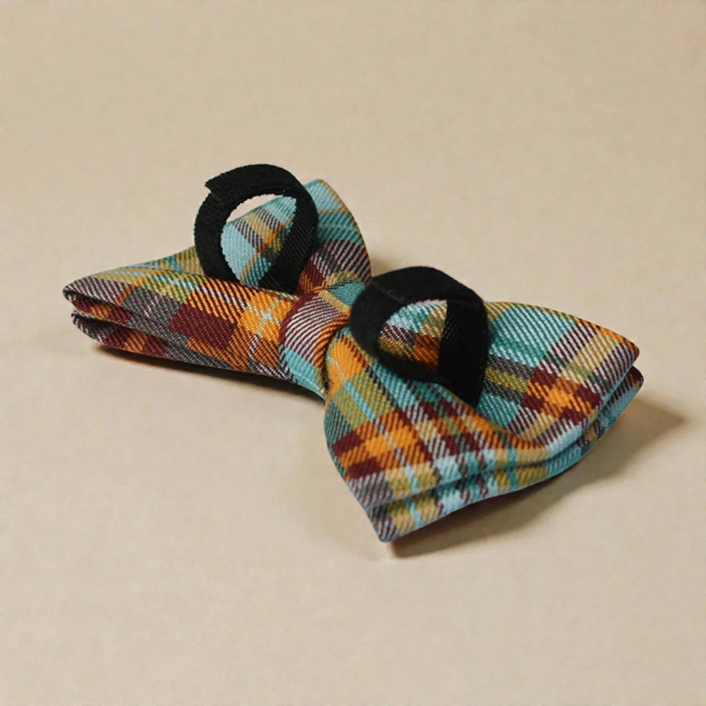 Plaid bow tie on a beige background