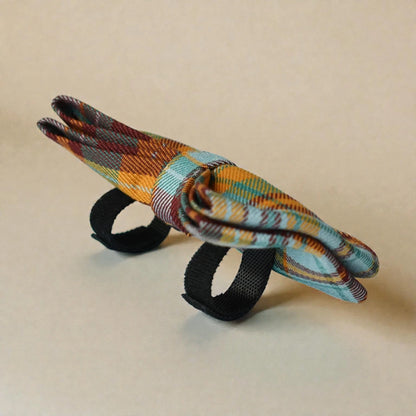 Plaid bow tie on a beige background