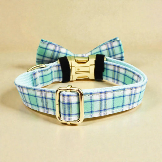 Plaid dog collar in green with a bow tie and gold buckle on a beige background