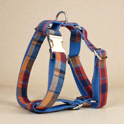 Plaid blue dog harness with metal buckle on a beige background