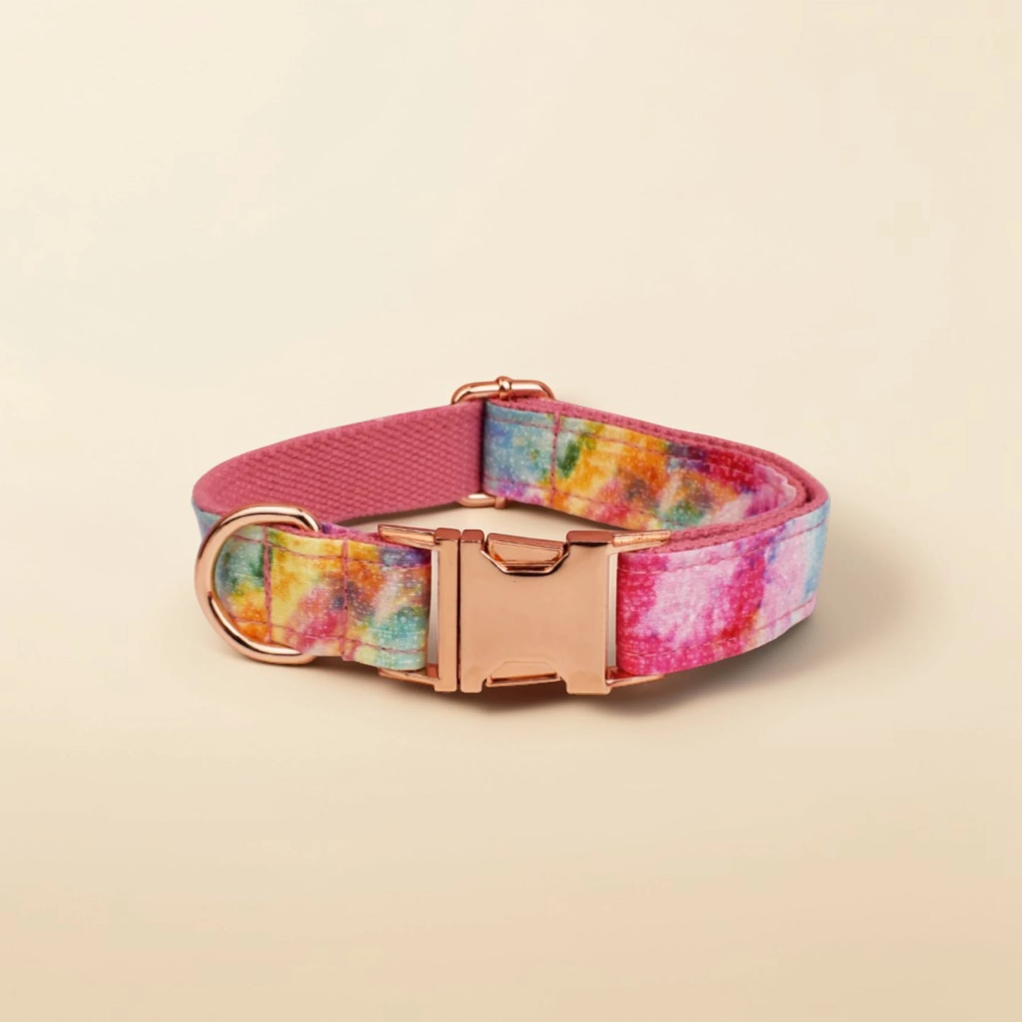 Colorful dog collar with a rose gold buckle on a beige background