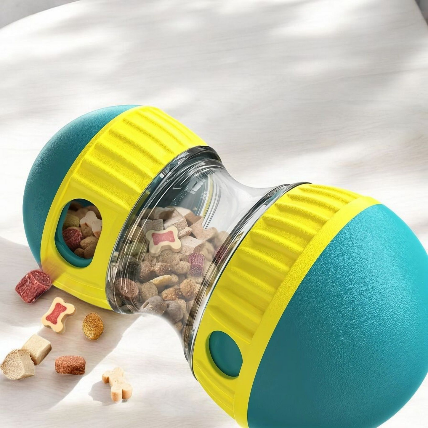 turquoise Pet toy with a transparent center filled with treats on a white background
