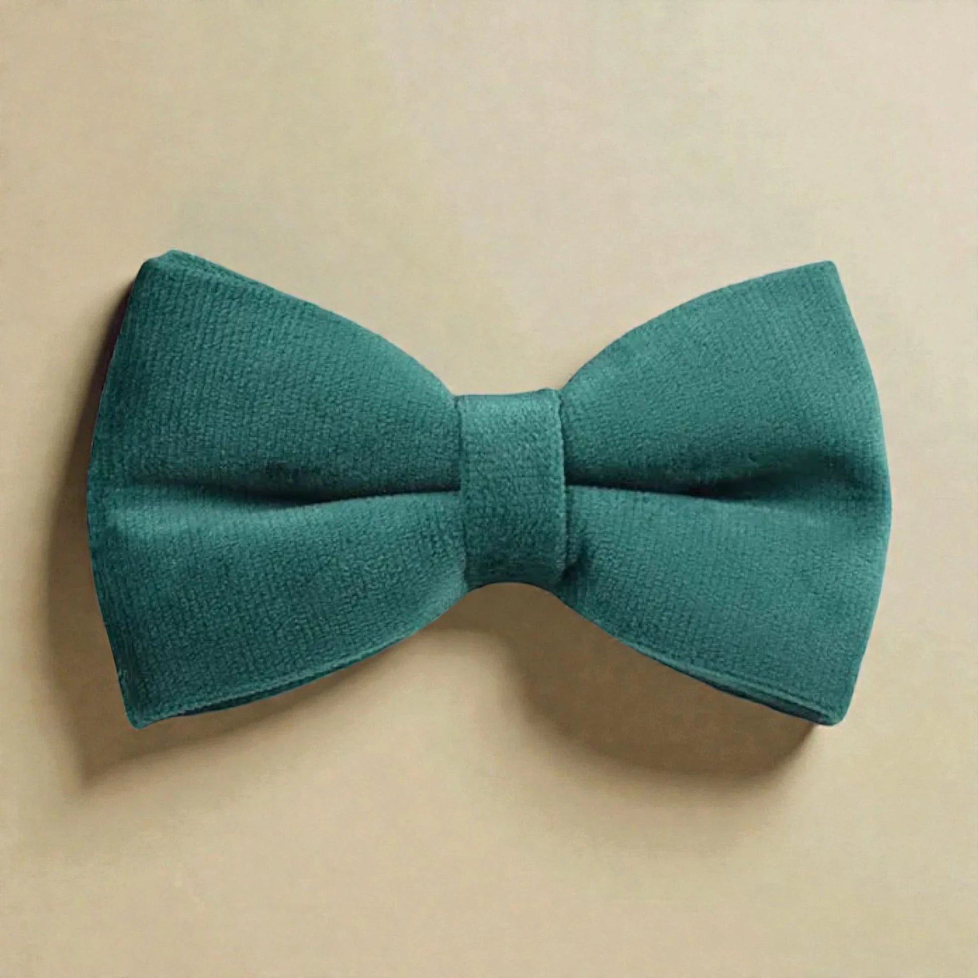 Green bow tie on a beige background