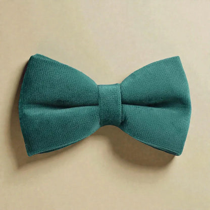 Green bow tie on a beige background