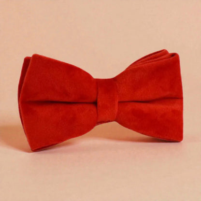 Red bow tie on a beige background