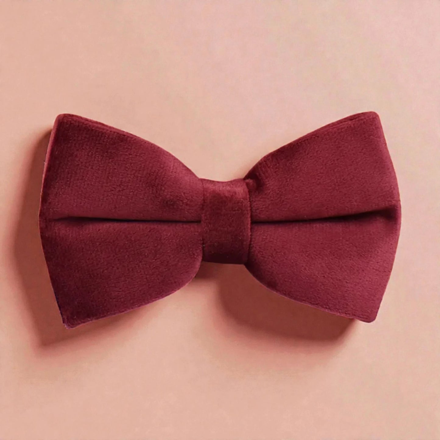 Red bow tie on a pink background