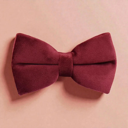 Red bow tie on a pink background