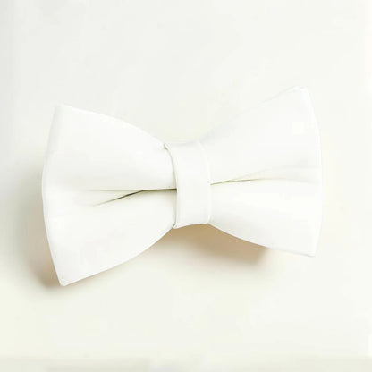 White dog bow tie on a light beige background